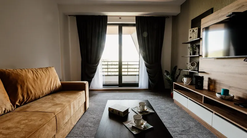 Modern living room with stylish furniture and a view of the outdoors in a cozy apartment setting