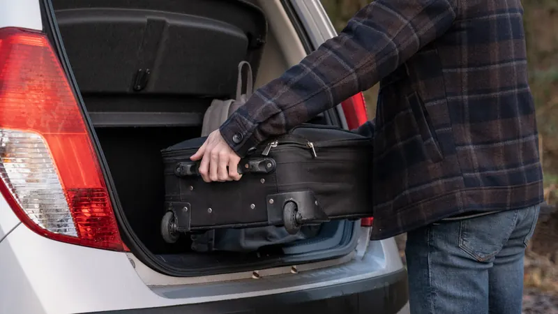 Packing Suitcase in Car Boot for a Holiday